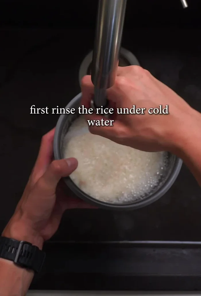 Rinse the rice under cold water until clear. Add to rice cooker with appropriate water amount.