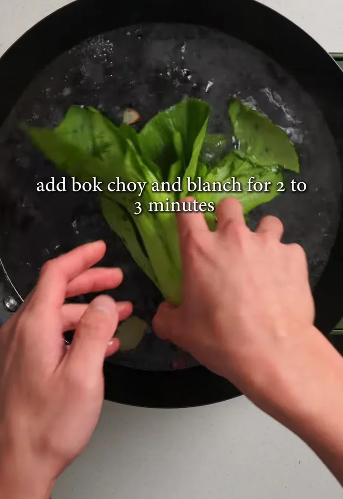 Add 2L of hot water, bring to a boil, add bok choy, and blanch for 2-3 minutes until tender. Transfer to ice water for 15 seconds, then drain and discard blanching water.