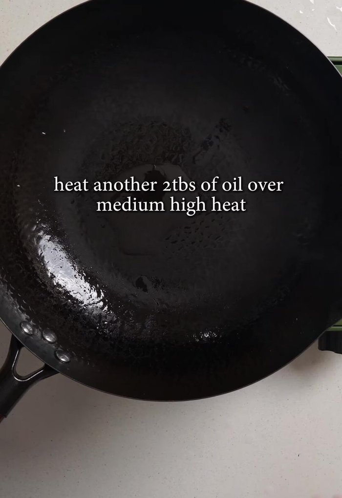 In the same pan, heat another 2 tablespoons of oil. Add remaining garlic and ginger, stir-fry until fragrant.