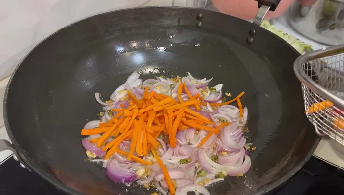 Add carrots and cabbage; fry for 2 minutes.
