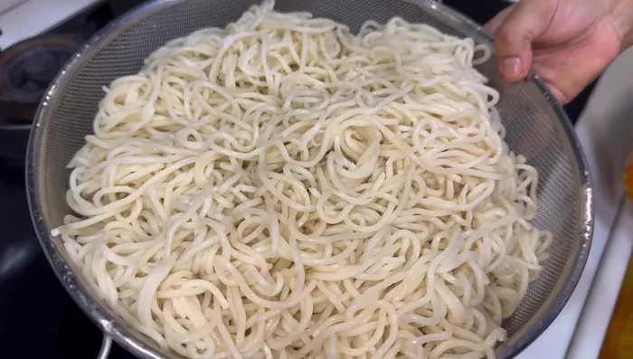 Strain noodles and rinse thoroughly with cold water to stop the cooking process.