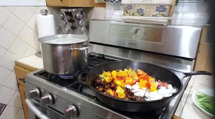 Add onions, bell peppers, and pineapple to the chicken and stir-fry for about a minute.