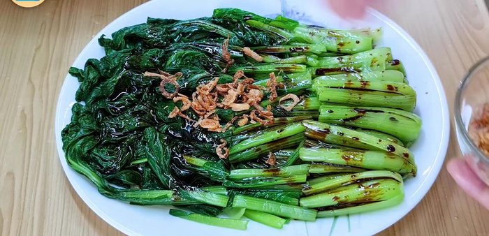Sprinkle crispy fried shallots over the choy sum.