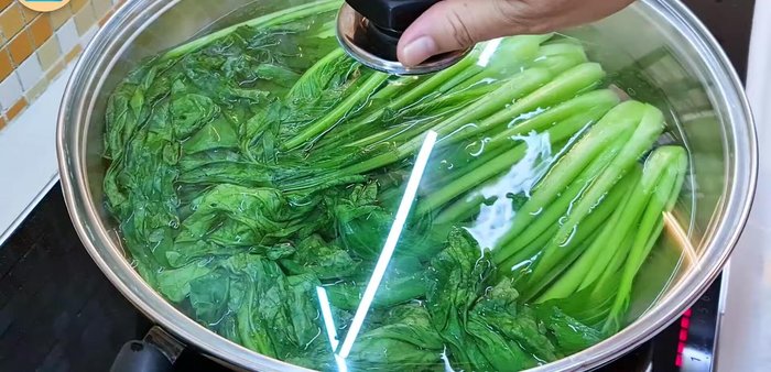 Boil for about 1 minute, then rotate the choy sum to ensure even cooking.