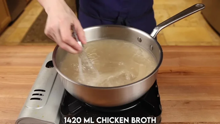 Make the broth: Prepare chicken broth according to package directions, substituting some water with shiitake mushroom soaking liquid. Season with salt, sugar, light and dark soy sauces, and grated ginger.