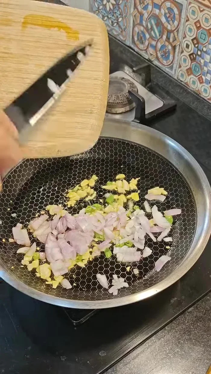 Add onions and fry until light brown.