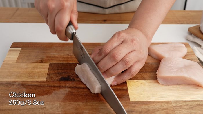 Prepare the chicken marinade: Mix thinly sliced chicken breast with soy sauce, sesame oil, cornstarch, and baking soda. Set aside.